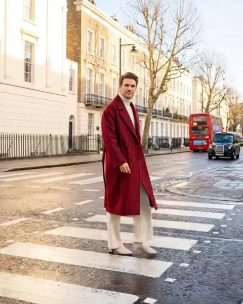 A still from a DesignerBox video: a woman in a red coat on a London street