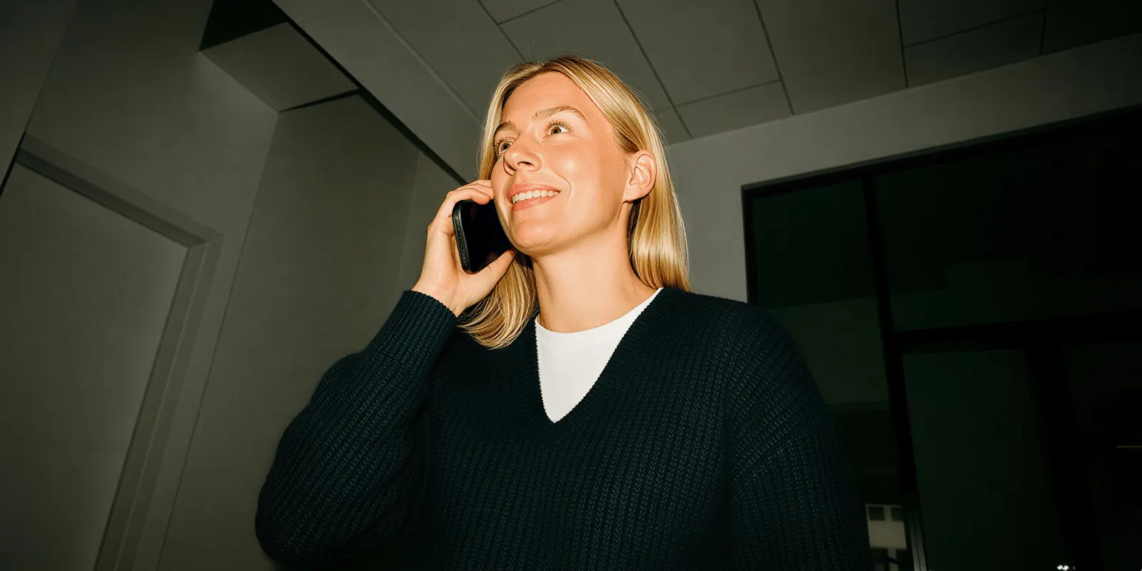 Woman in an office talks on the phone, the kind of call a brand makes to ask an agency how its ads are approved