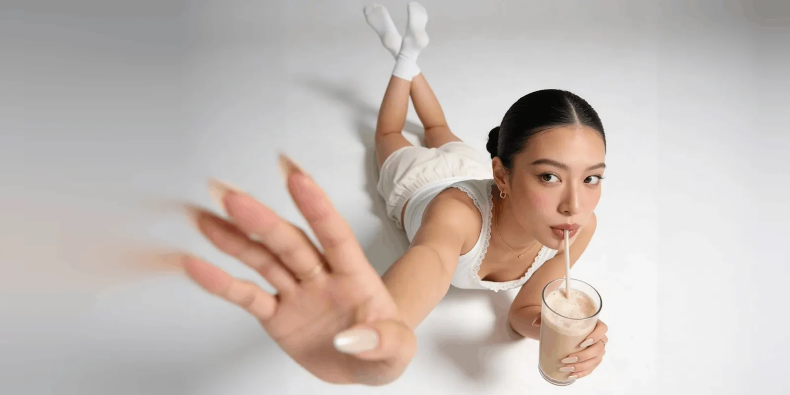 A hand reaching for a drink mid-use, the kind of first frame a TikTok demo open starts on with the product already in motion