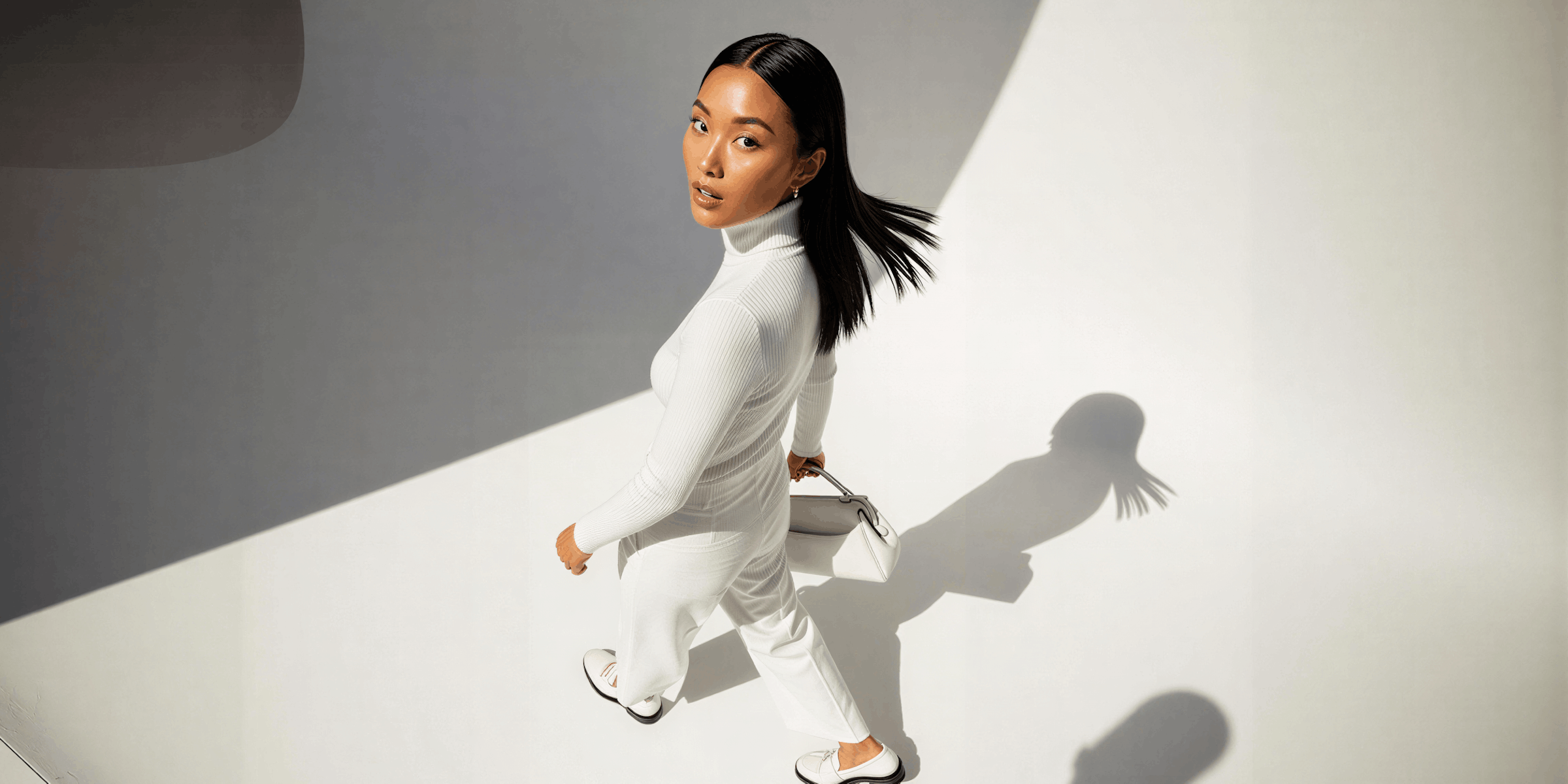 Editorial ad shot using hard directional light and a long cast shadow, one of the cinematic ad styles